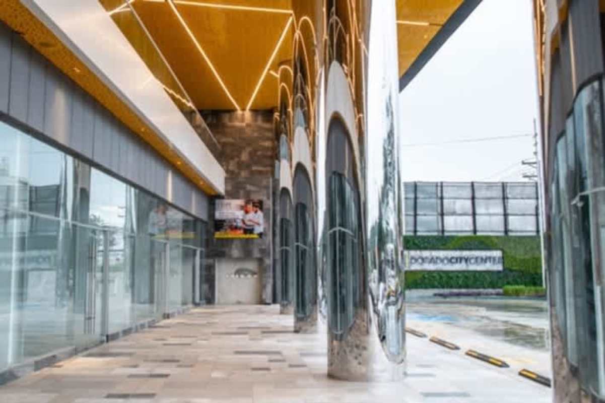 Warehouse style unfinished interior with mezzanine and concrete stair in Panama City commercial plaza