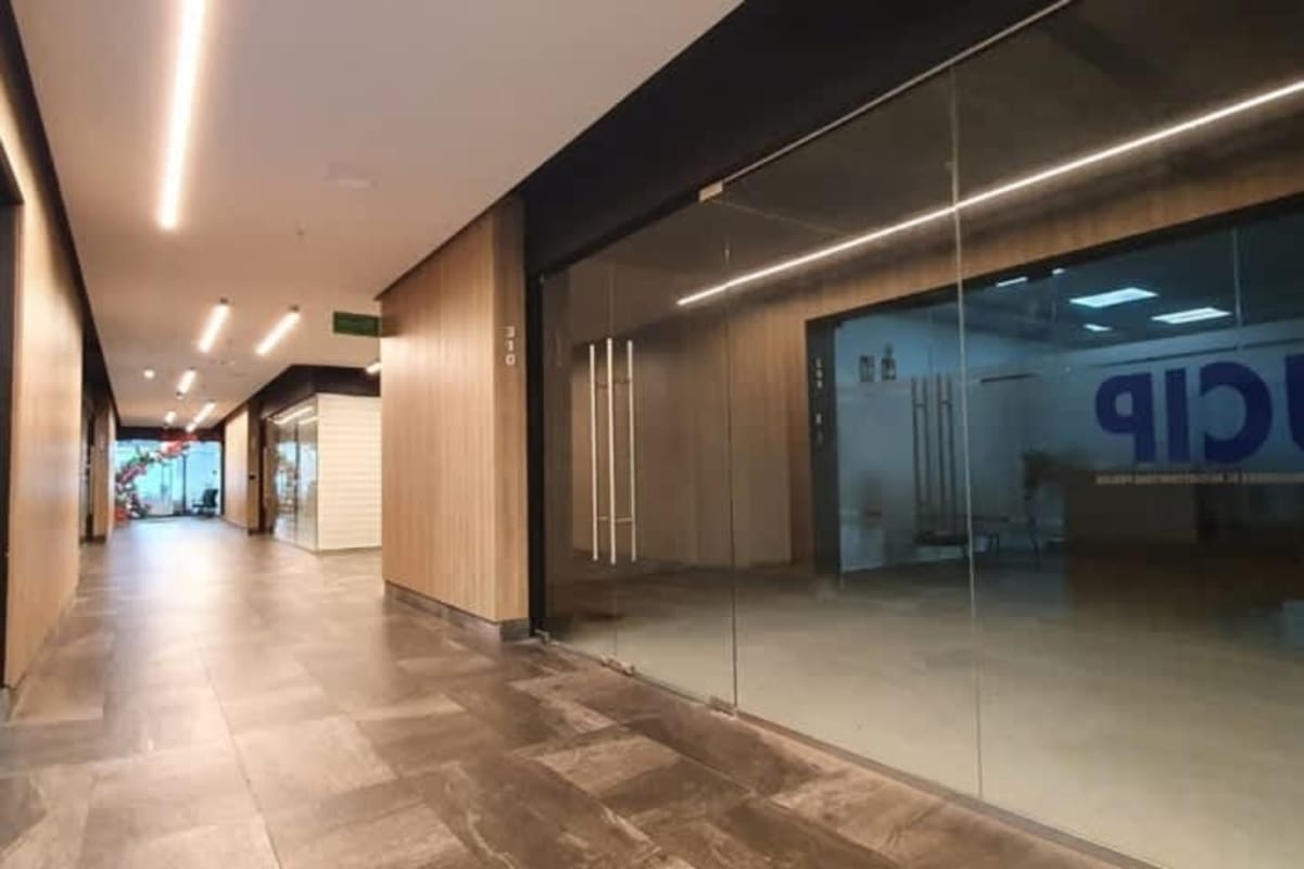 Commercial corridor with glass storefronts polished tile at El Dorado Business Plaza Panama