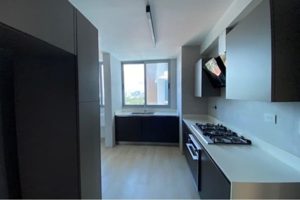 Spacious modern kitchen with granite countertops, premium cabinets, and city view window in PH Quartz Tower Panama