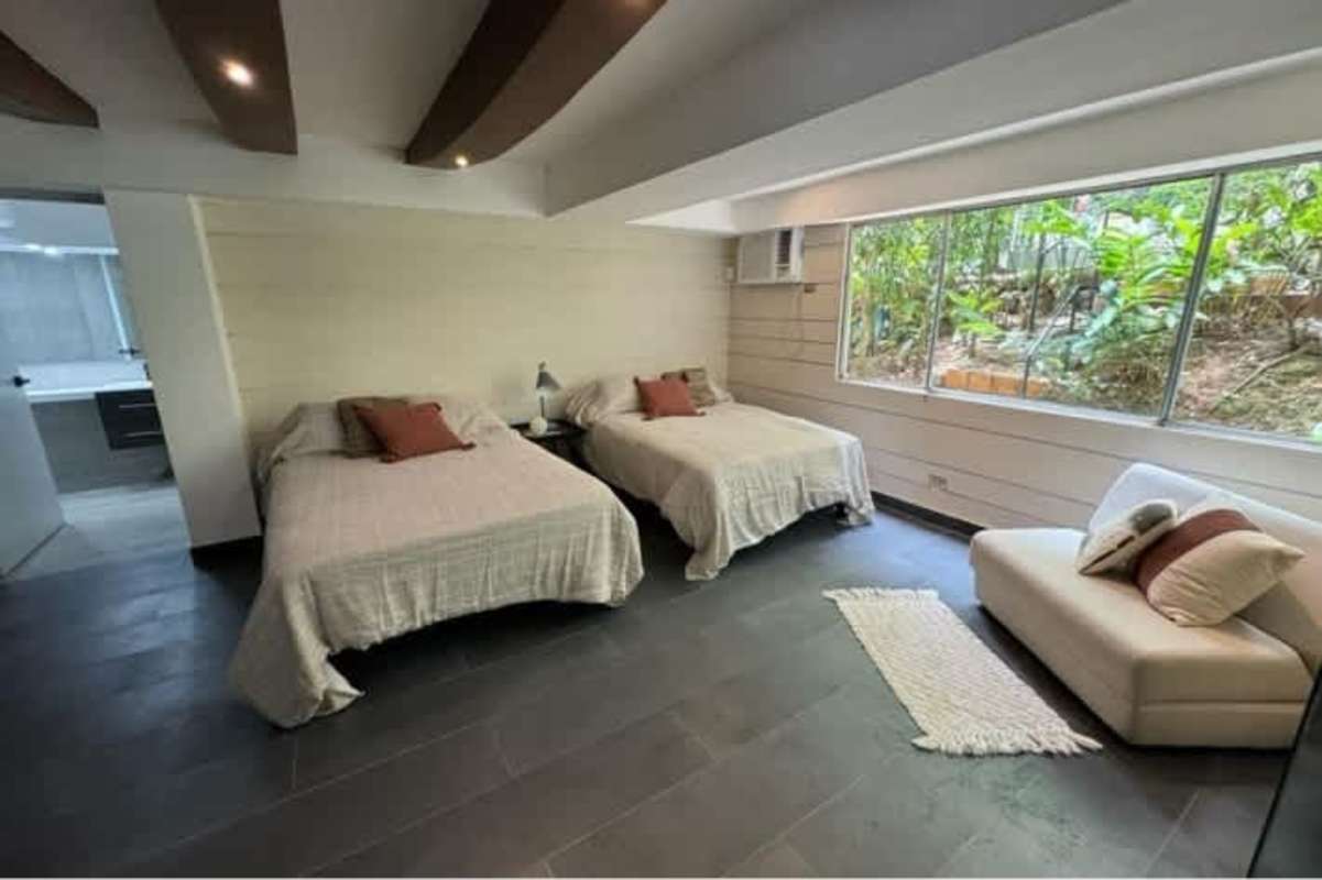 Bright bedroom with balcony access garden views in multi-unit house Albrook Panama