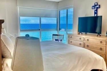 Luxury beachfront condo living space with panoramic windows at PH Riomar Panama