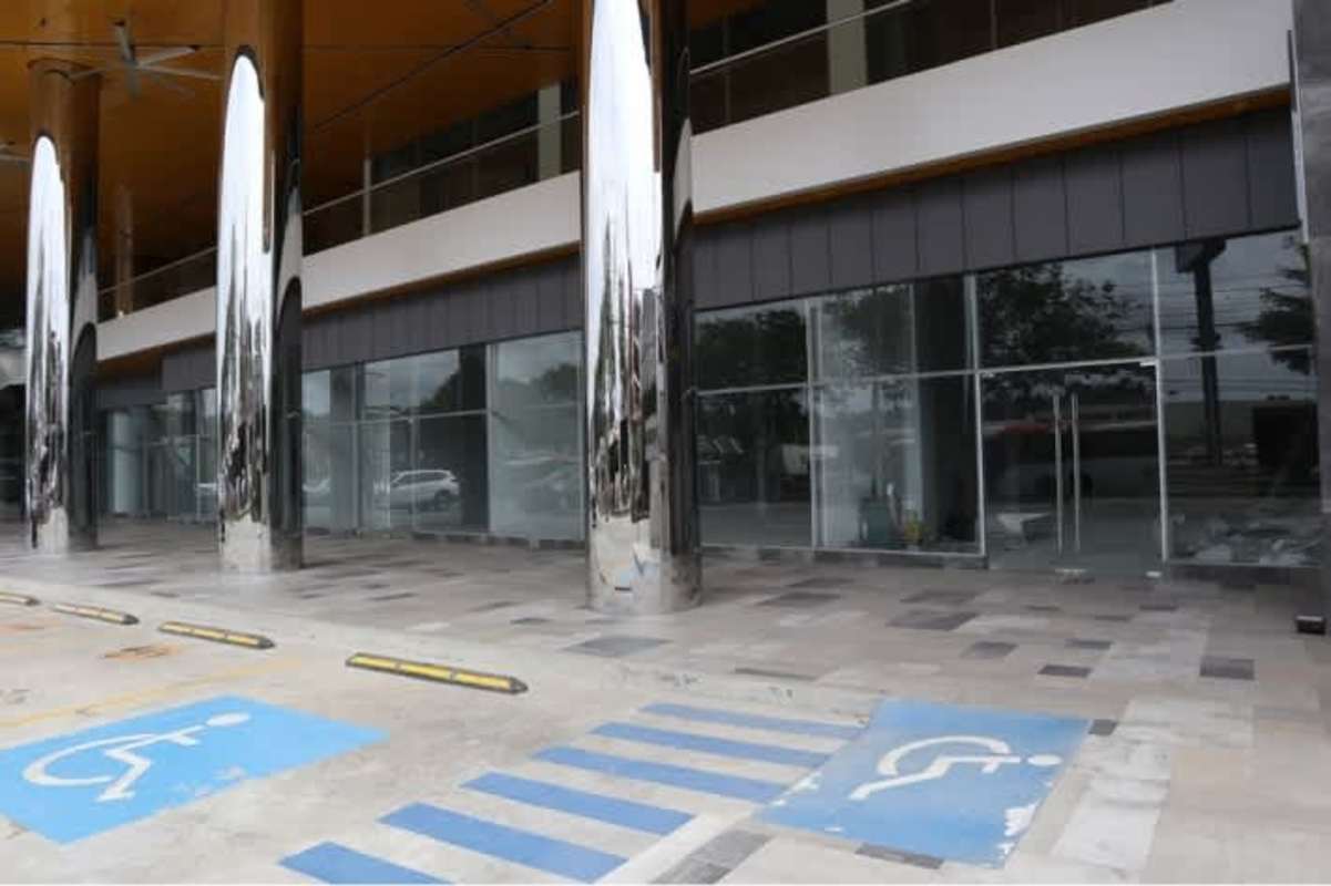 Commercial building glass facade street view with parking at El Dorado Plaza Panama City