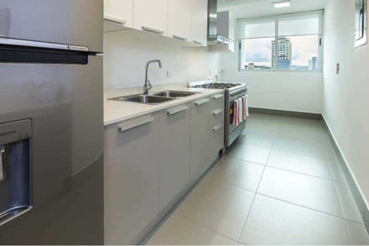 Contemporary kitchen with stainless steel fridge, gas stove and ample window views PH Altamira Residences Panama City