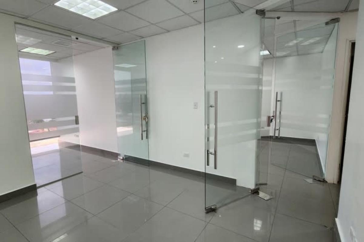 Modern empty office unit with floor-to-ceiling windows and glass partitions in PH Torre Aseguradora Ancón Costa del Este Panama