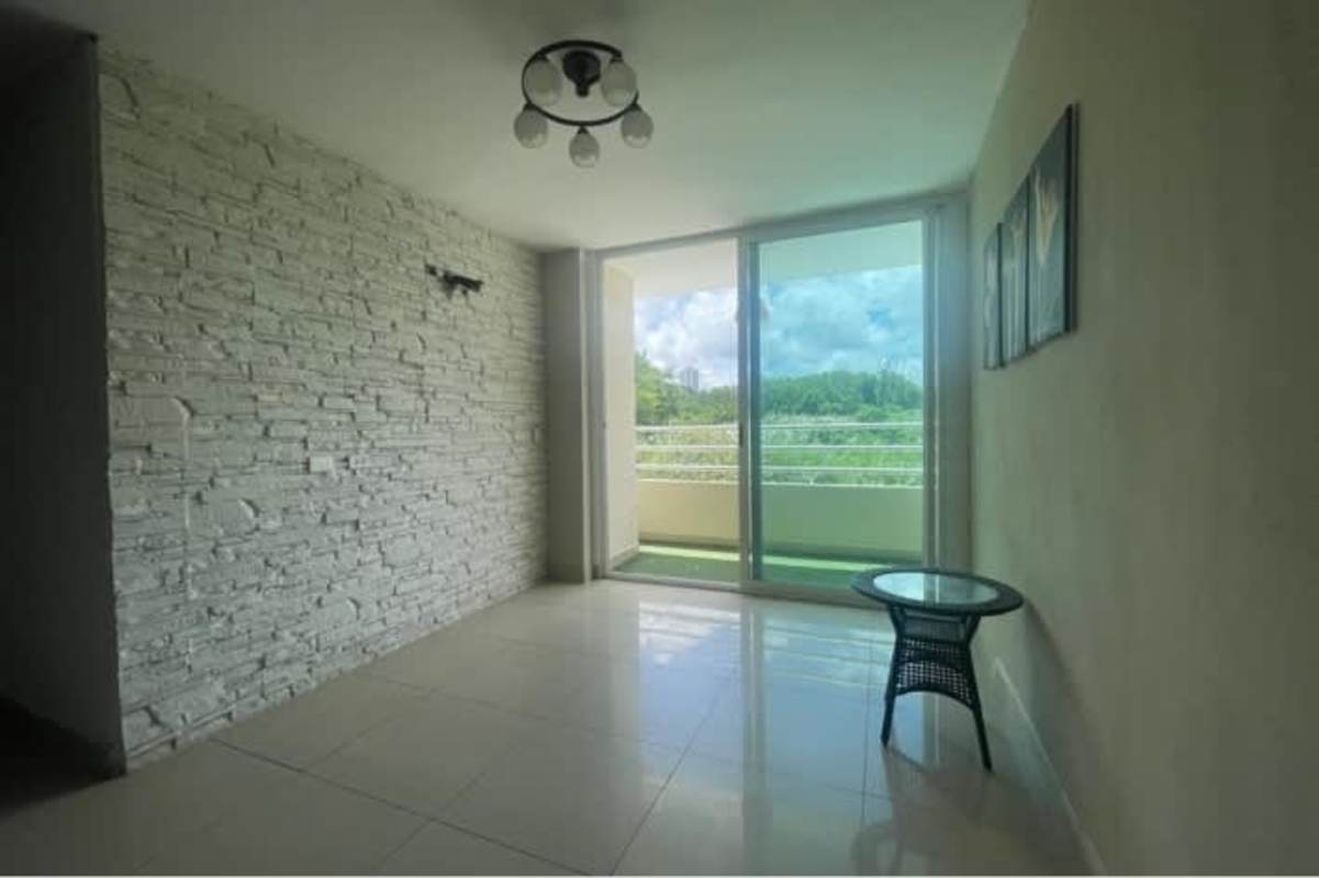 Bright living dining space with large sliding doors and balcony at PH Condado Country Club Panama City