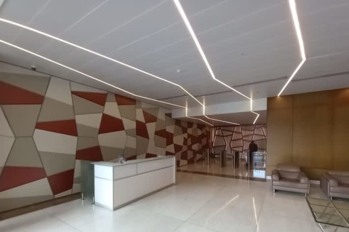 Contemporary reception hall with geometric design, secured entry turnstiles and seating area in PH Obarrio Business Tower