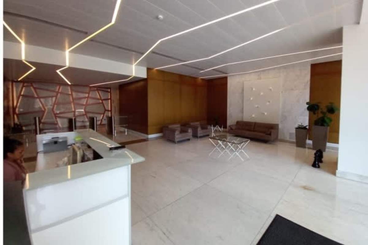 Interior raw space office in Obarrio with concrete floor and city skyline through floor-to-ceiling windows