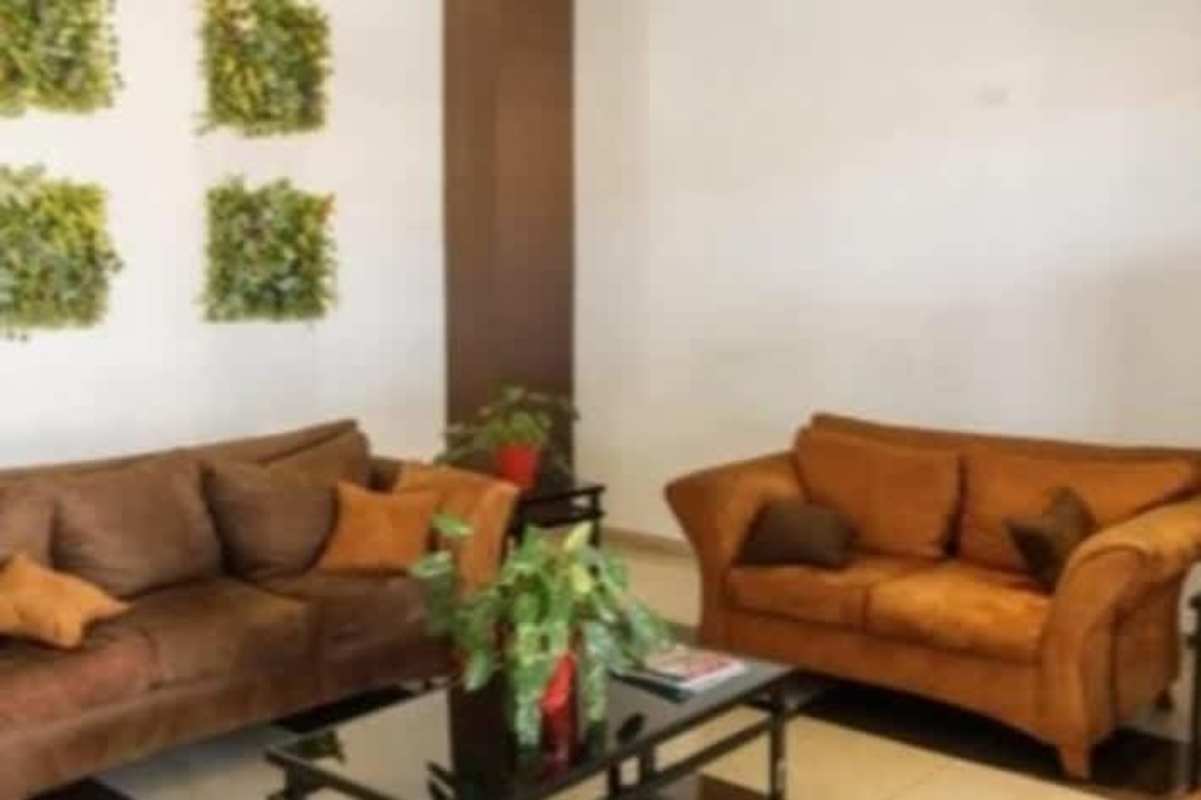 Living room with modern design, tiled floors and large windows at PH Sky Point Panama City