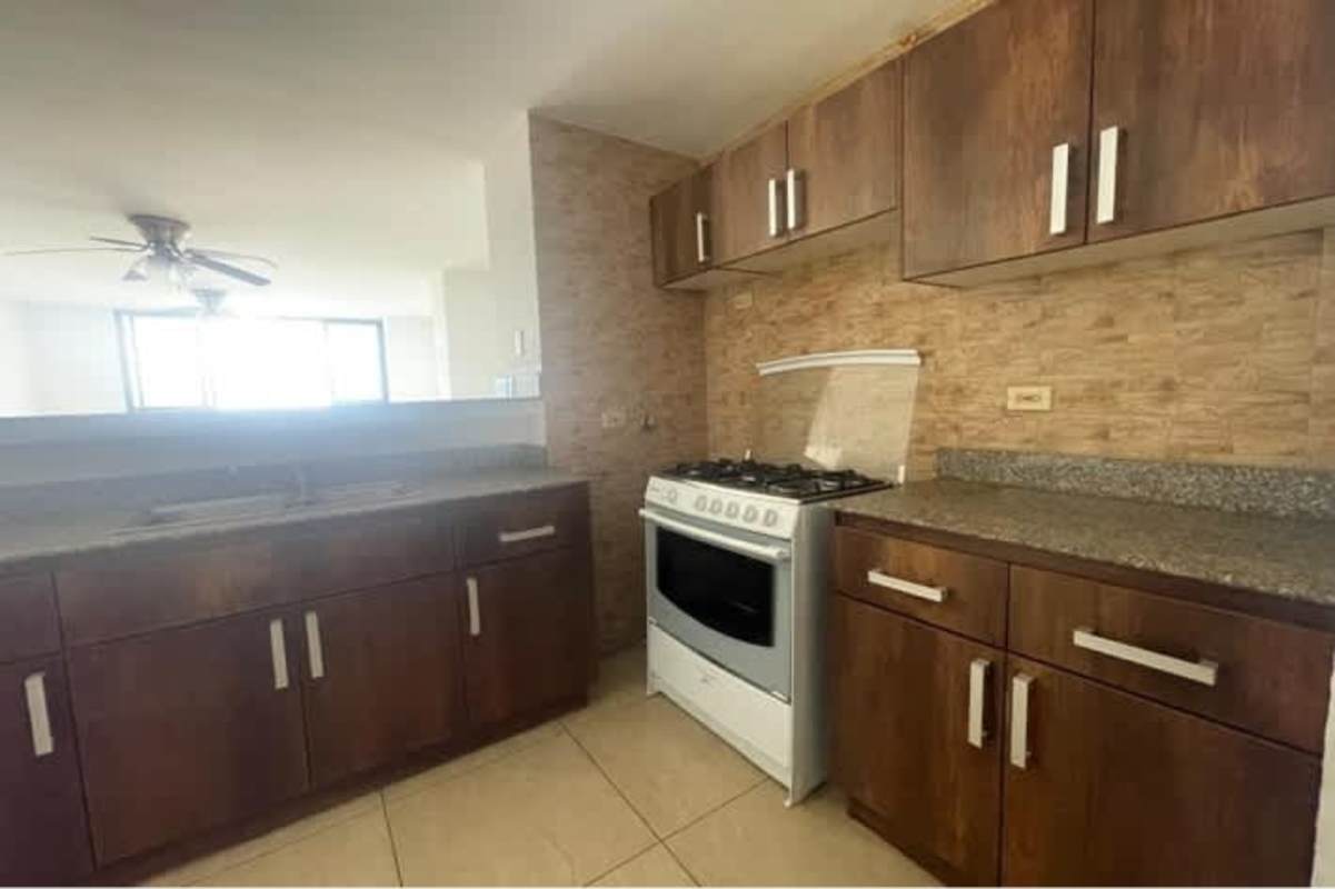 Kitchen with granite countertops, stove, washer Dryer PH Condado View Panama