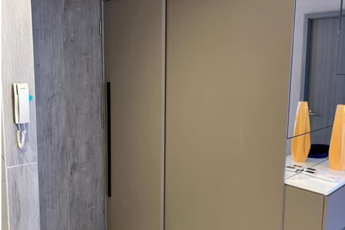 Open kitchen with marble counters, built-in stove, overhead cabinets in BICSA Tower Panama City