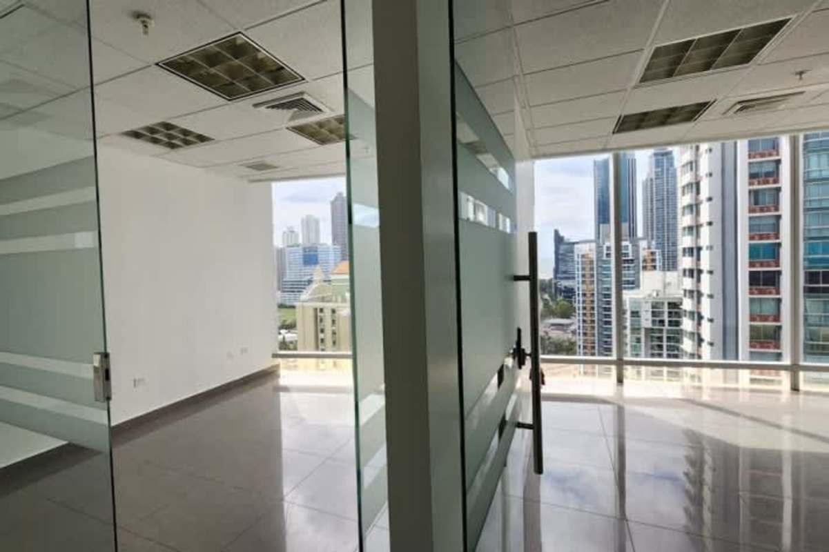 Modern hallway with glass divisions and tiled floor in commercial tower office Panama City