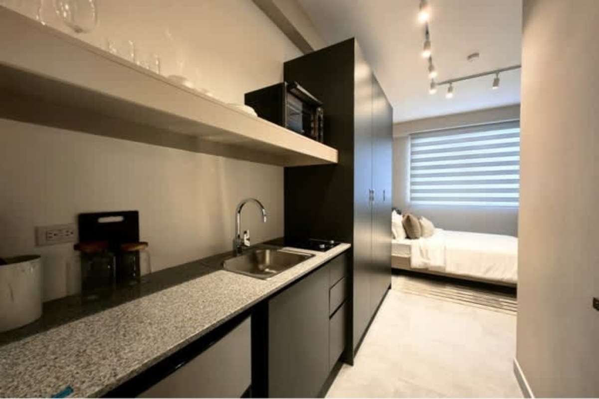 Minimalist bedroom with padded headboard and modern decor in PH The Park Panama City