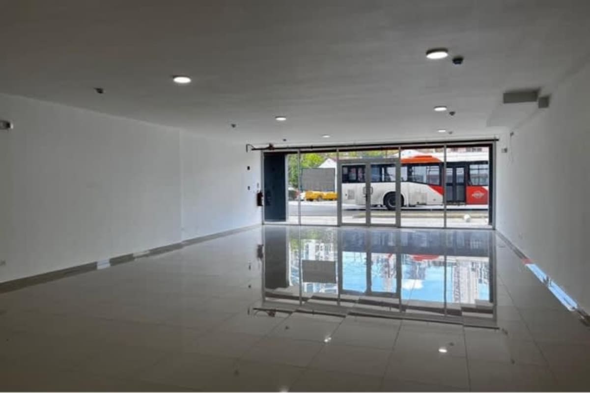 Large tiled empty interior with glass storefront at Signature Point Bella Vista Panama City