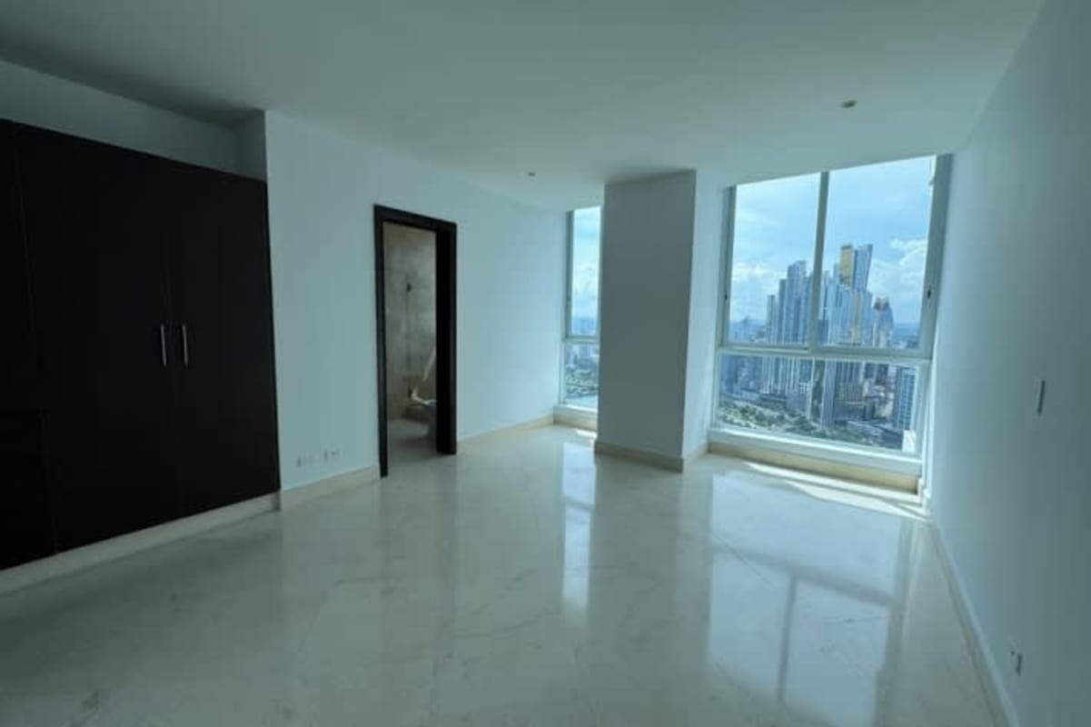 Modern bathroom double sink marble walls glass shower at high-end Punta Paitilla Panama apartment for rent