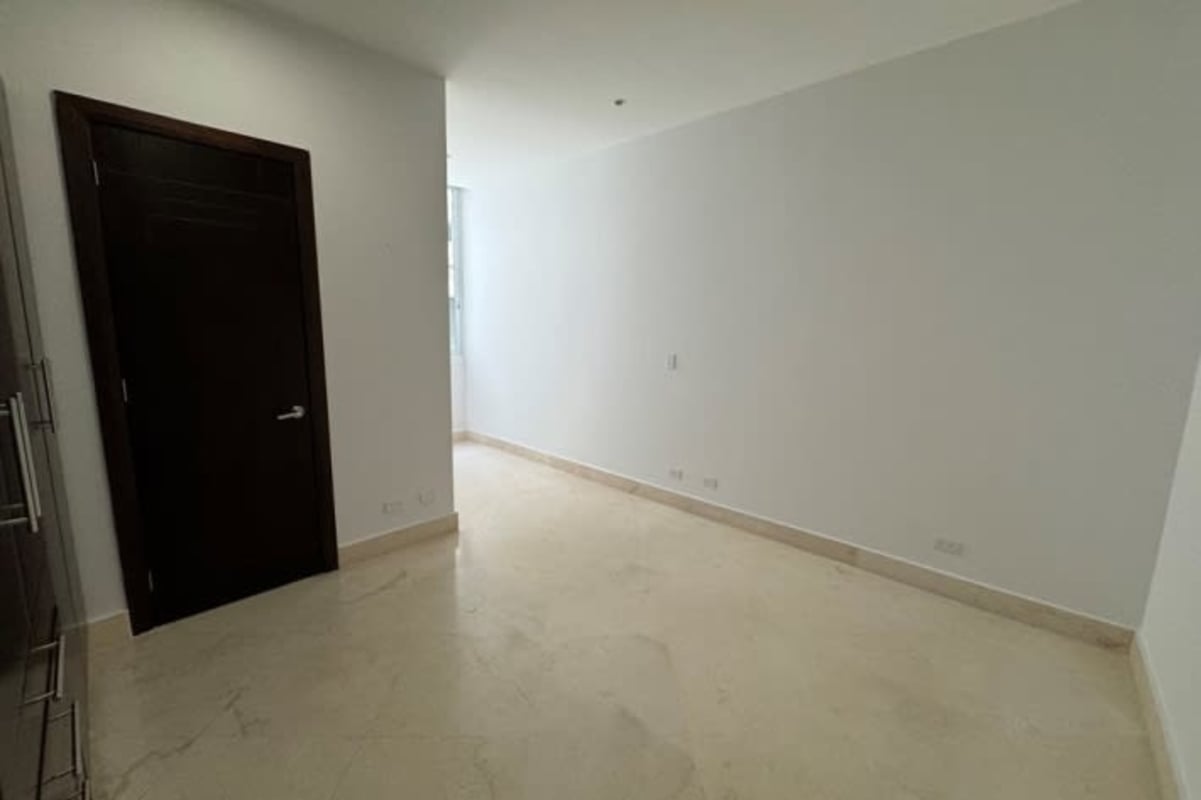 Bedroom with built-in wardrobe floor-to-ceiling windows panoramic Pacific ocean and city skyline views