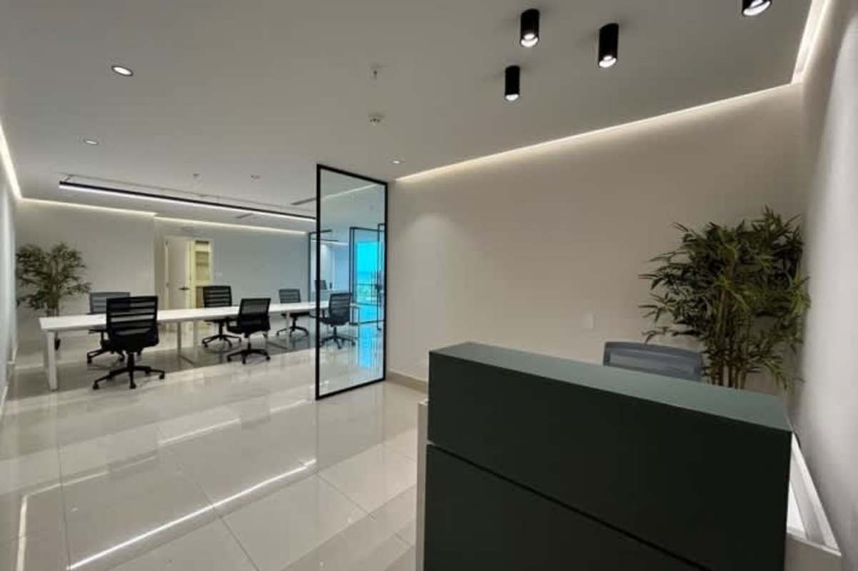 Open-plan office space with workstations and glass walls in Costa del Este Business Center