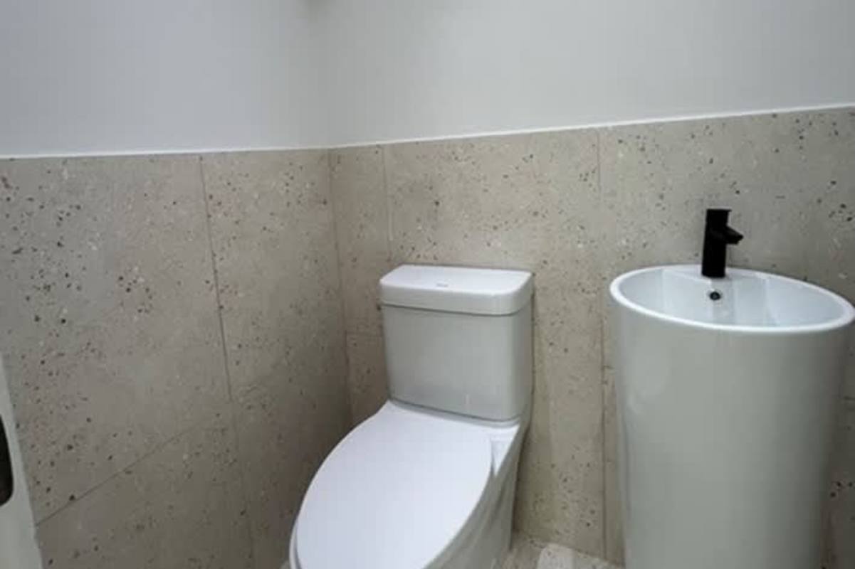 Dual toilet stalls with pedestal sinks modern bathrooms Costa del Este