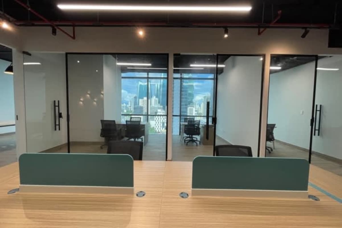 Private office with wooden desk chairs large windows and skyline views in PH F&F Tower Obarrio Panama