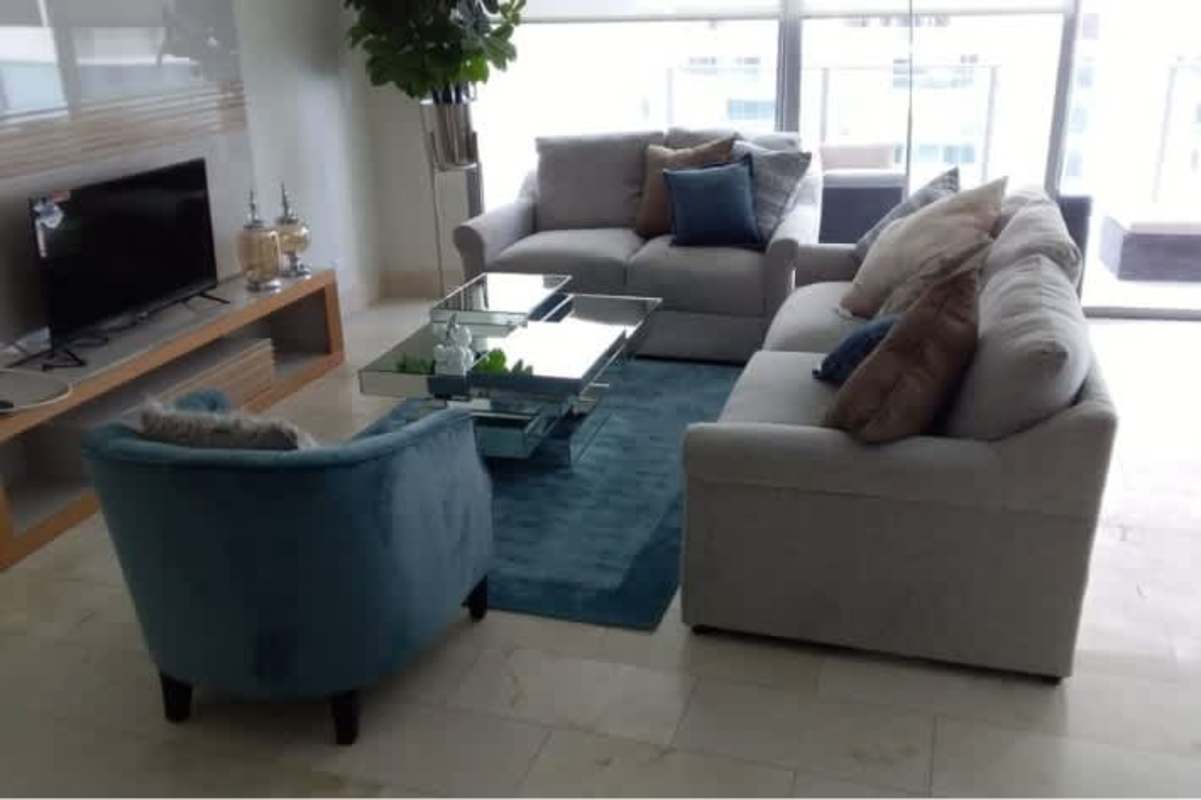 Luxury master bedroom with large windows, upholstered bed, wooden floors at PH Oceanaire Punta Pacifica Panama