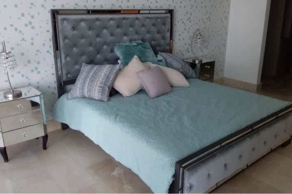 Second bedroom with tufted bed, mirrored nightstands in PH Oceanaire Panama