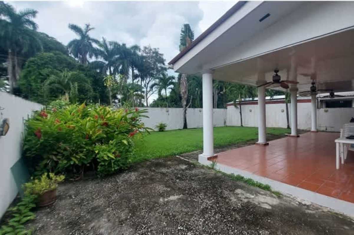 Spacious covered terrace overlooking green garden at house in Margarita Colon Panama