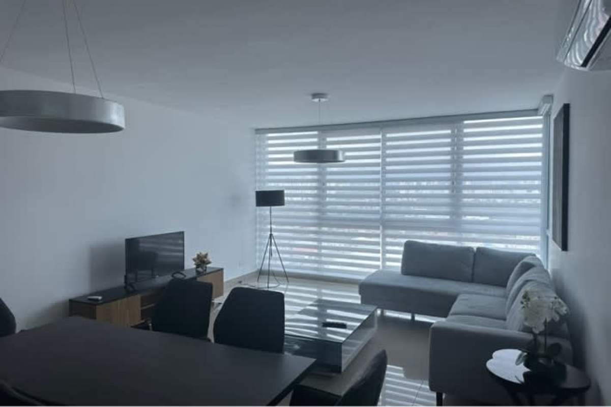 Spacious living and dining room furnished with minimalist decor in PH Mirador Costa del Este