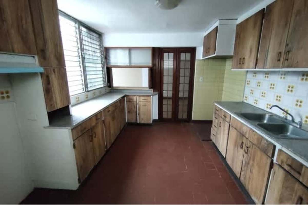 Bright living room with tile floor and terrace access in Bella Vista apartment Panama