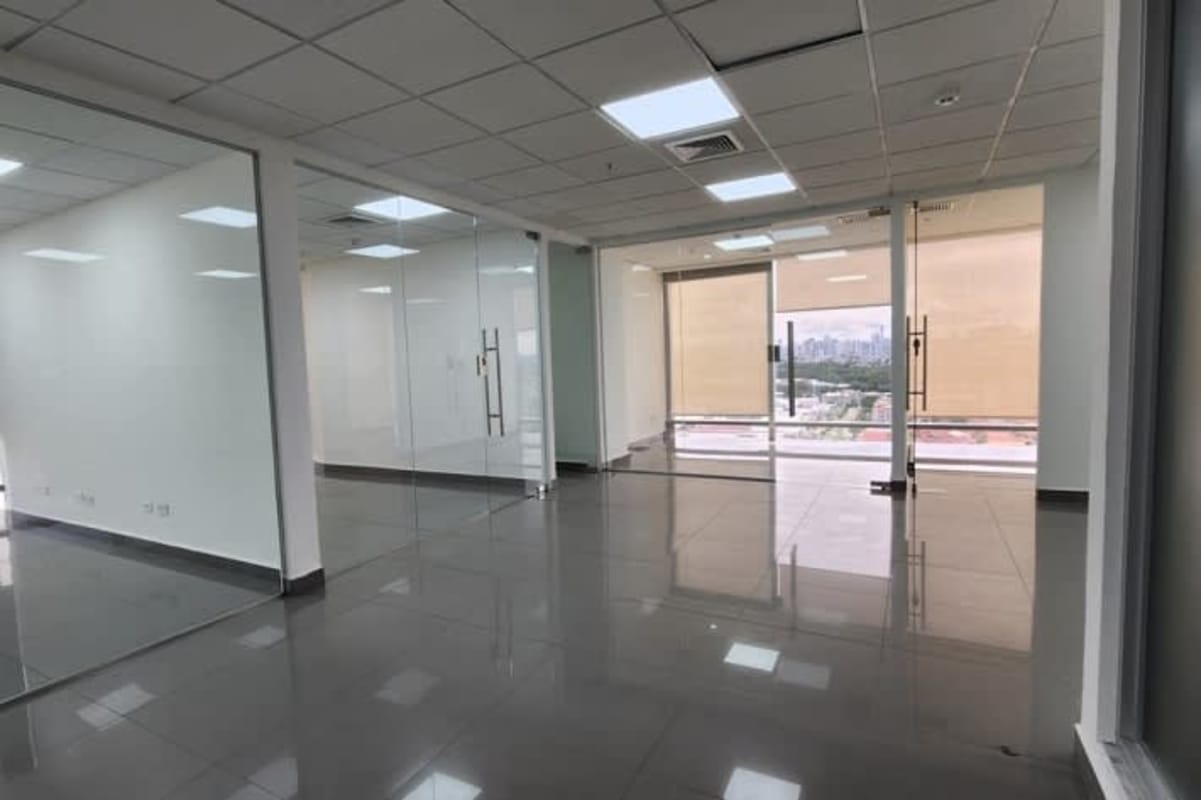 Glass wall office space with tiled floors drop ceiling modern corporate interior Torre Aseguradora Ancón
