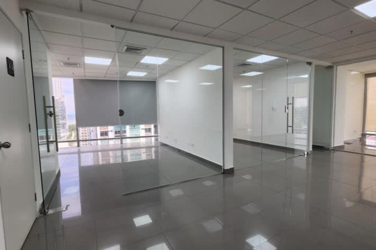 Office with glass partitions large windows tile floors in corporate tower Panama City