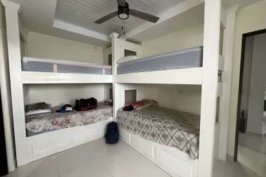 Bedroom with built-in bunk beds ceiling fan tile flooring white design Palenque Colon Panama
