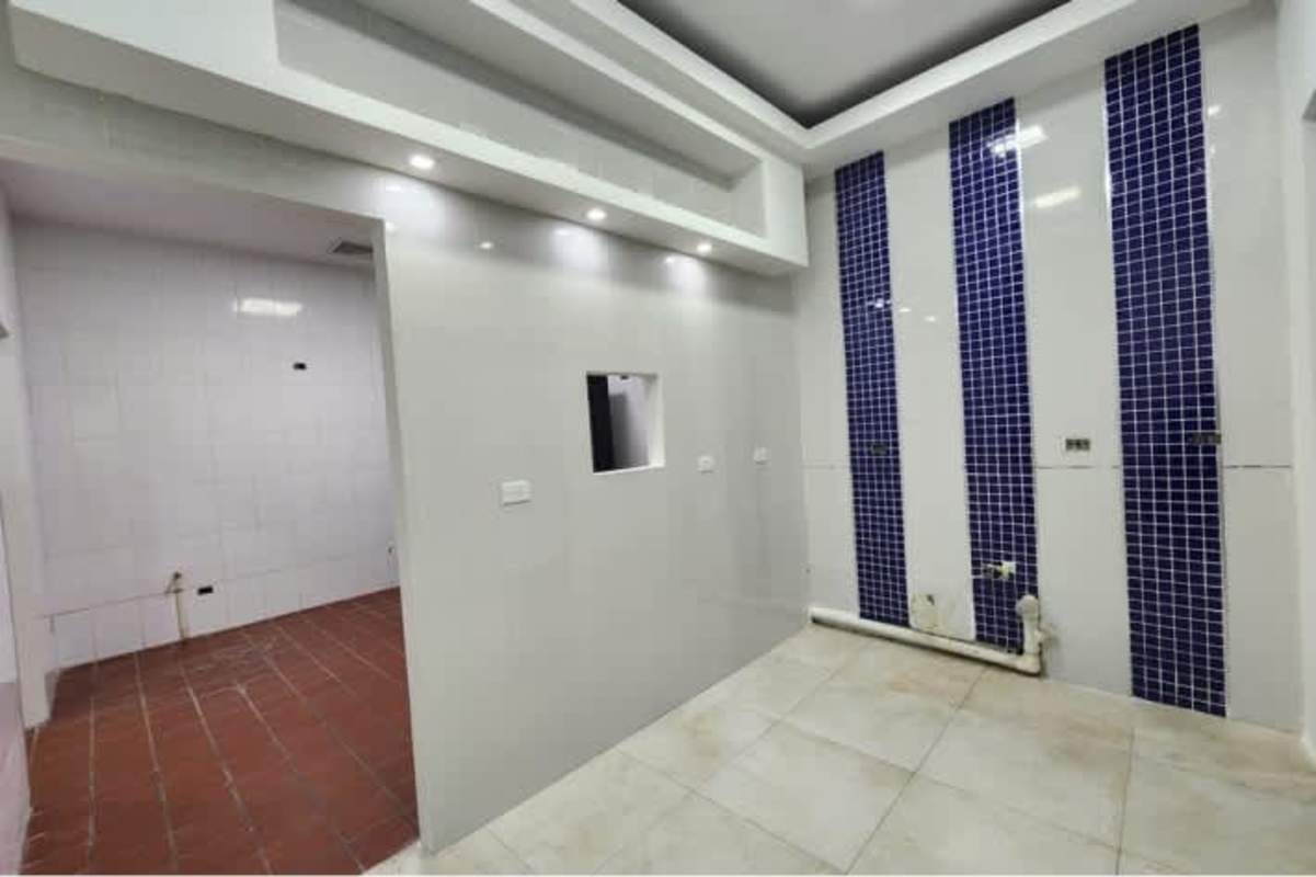 Kitchen buildout area with white walls, blue tile accents PH Torre Banesco restaurant commercial space Panama