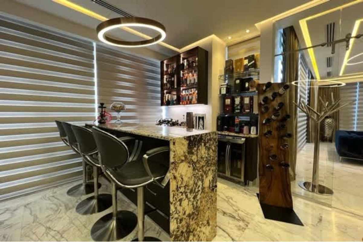 Spacious dining room with marble floors, large windows, and chandelier PH Costanera Panama