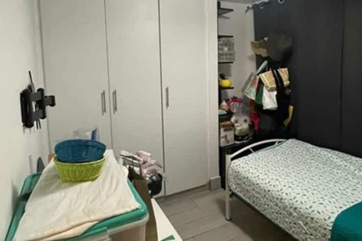 Small bedroom with white wardrobes, shelving, and window at PH Splendor By The Park Carrasquilla Panama