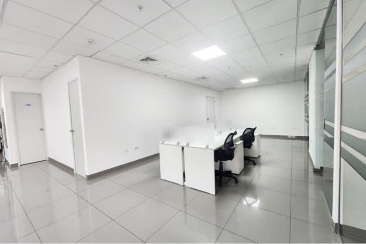 Modern conference room with large table and mesh chairs in Torre Aseguradora Ancón Costa del Este Panama