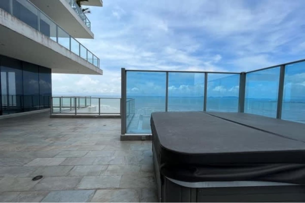 Balcony terrace with jacuzzi, glass railings, overlooking Pacific Ocean in Costa del Este penthouse