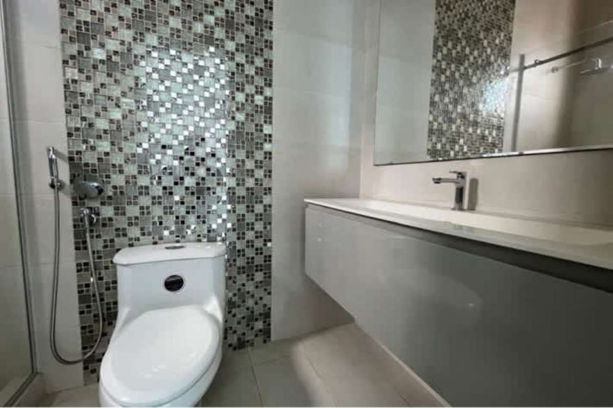 Bathroom with mosaic tile, modern fixtures, glass-enclosed shower in luxury penthouse