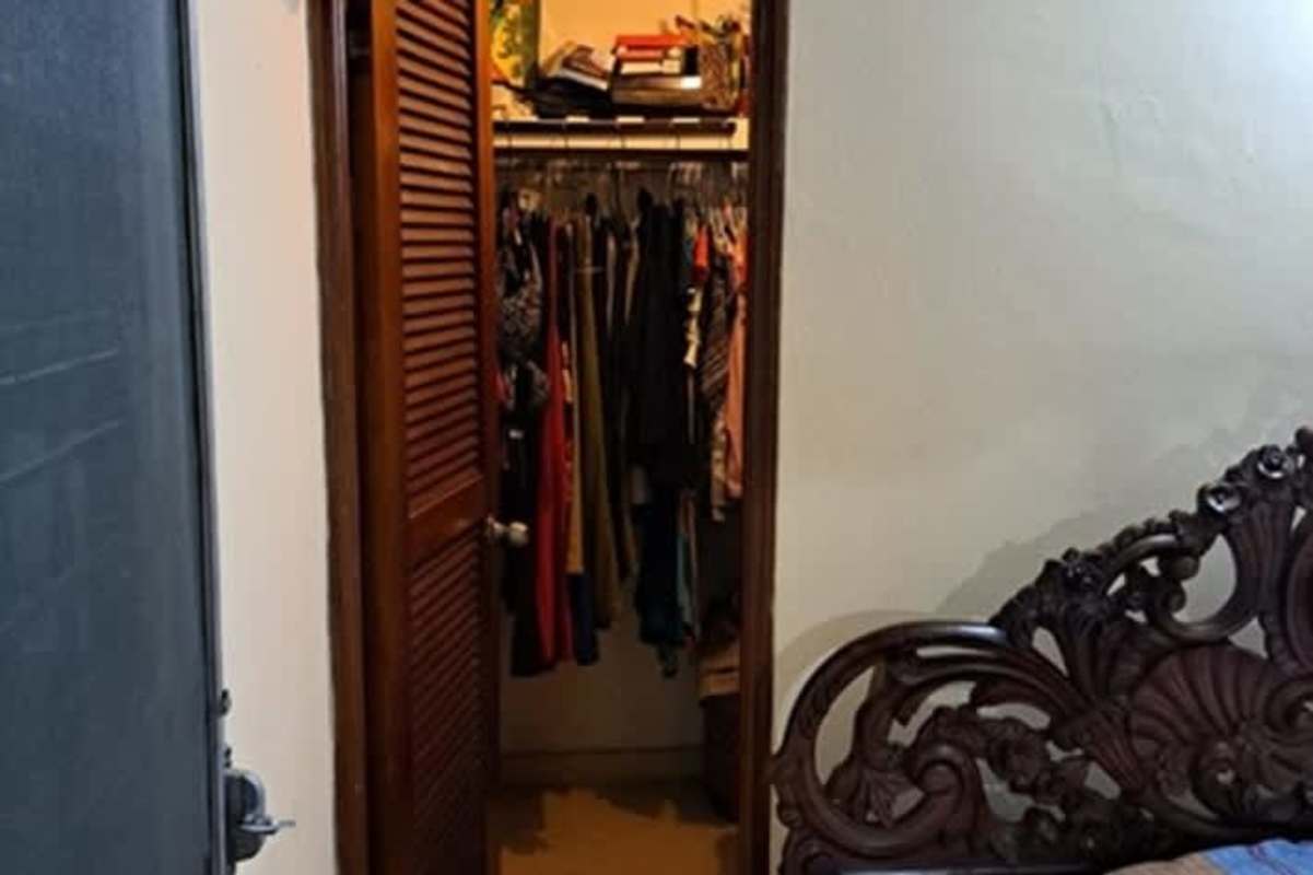 Traditional bedroom with closet and carved wood bed in Las Américas Mañanitas Panama