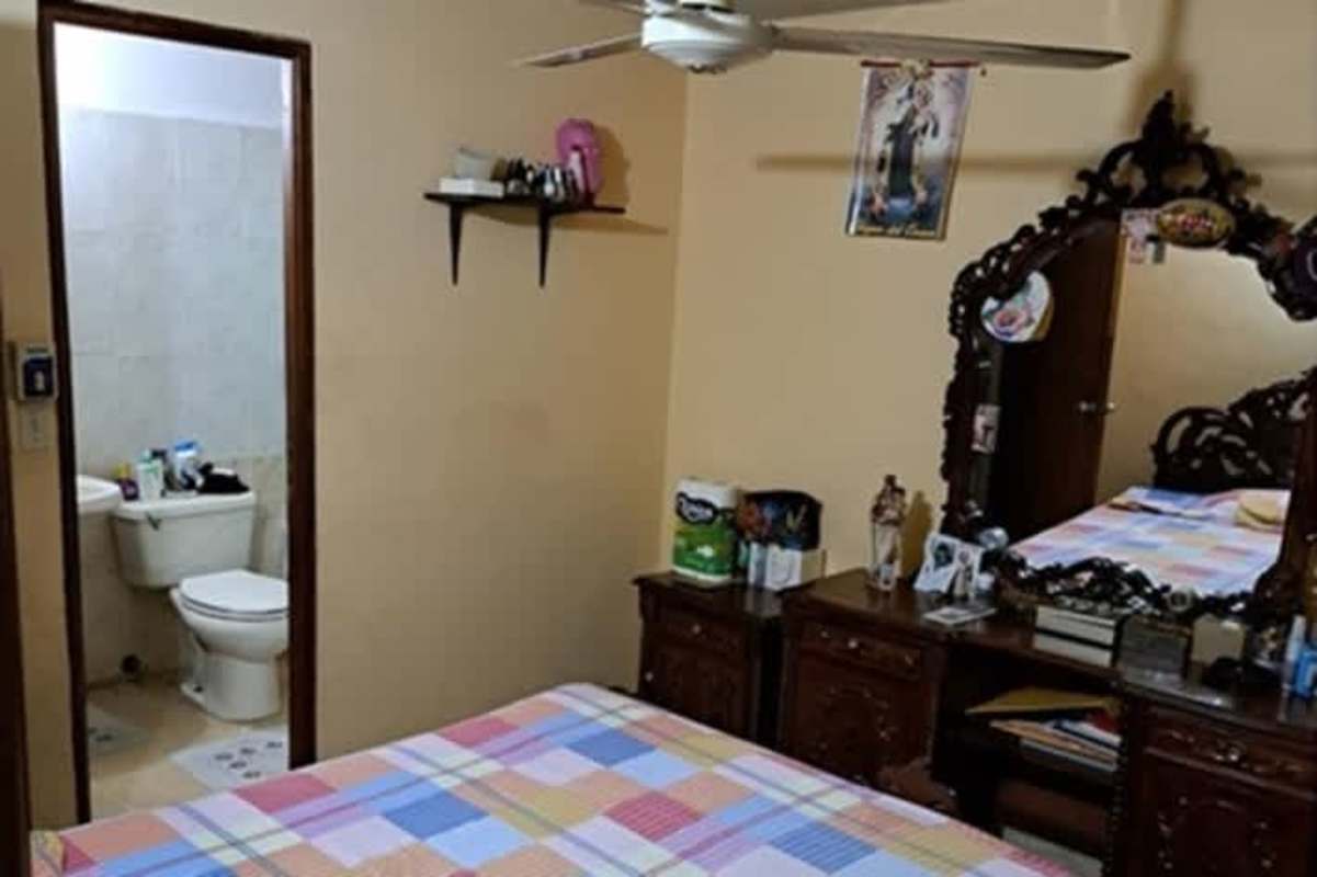 Bedroom ensuite, ceiling fan, wardrobe, colorful bedding Las Americas Panama