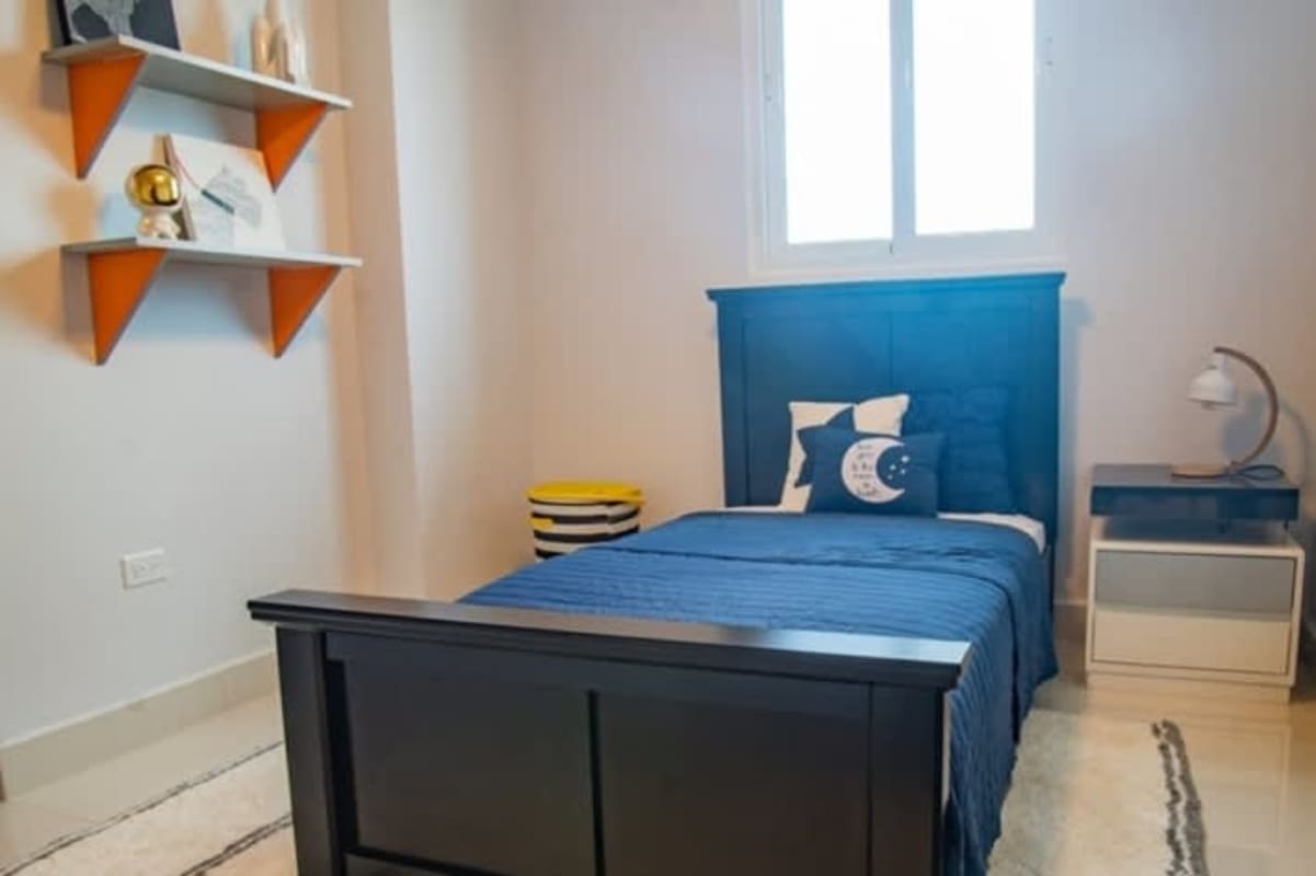 Modern apartment building lobby with seating at PH Alto Río Panama City