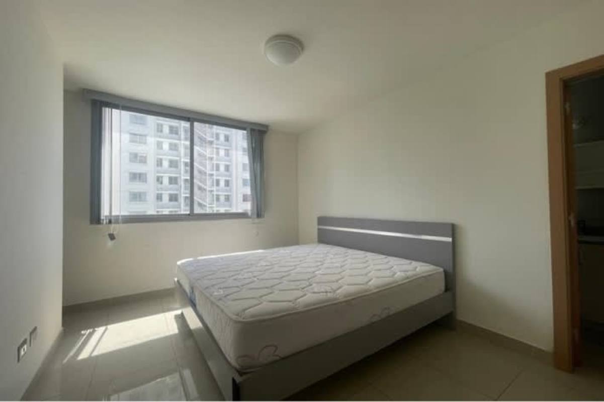 Spacious bedroom with tile floors and city view window Panama