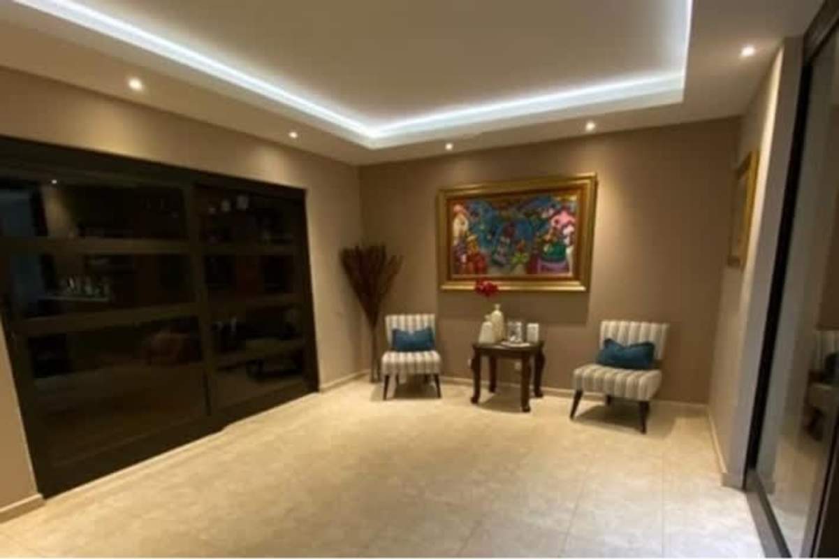 Modern living room with accent chairs and designer lighting luxury duplex Costa del Este Panama