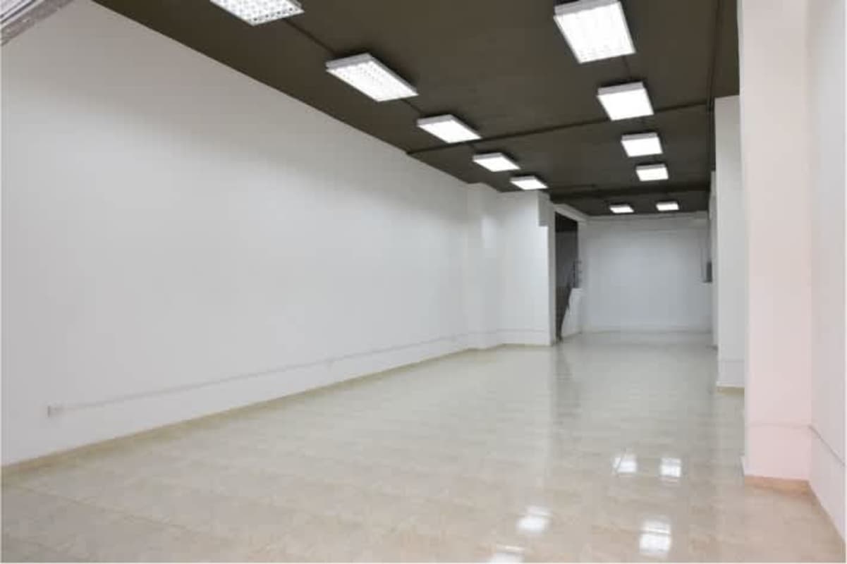 Commercial interior white walls black ceiling tiled floor in Edificio Don Goyo Panama