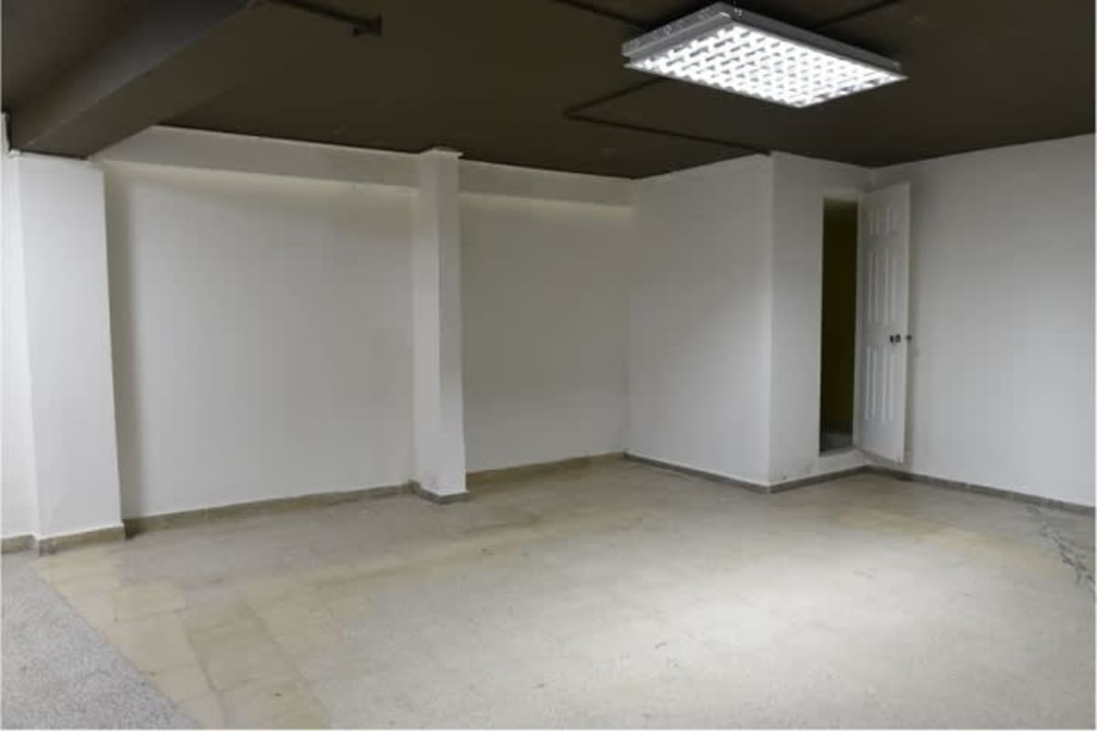 Tiled floor open retail space with black ceiling in Don Goyo Building Panama