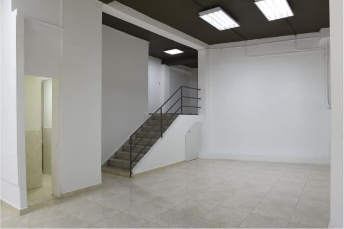 Minimalist commercial unit with white walls and tiled flooring Edificio Don Goyo Panama