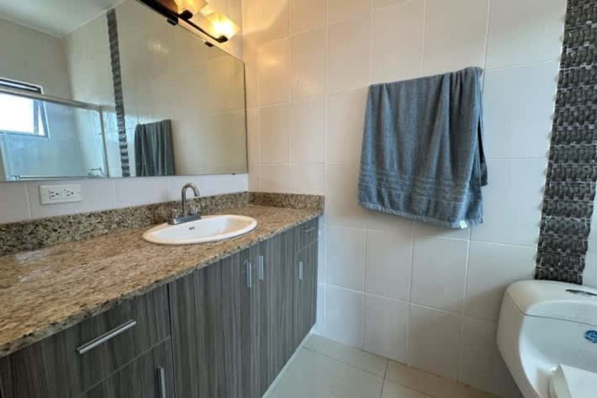 Open plan living dining area with city skyline views and balcony access at PH Alfa Betania Panama