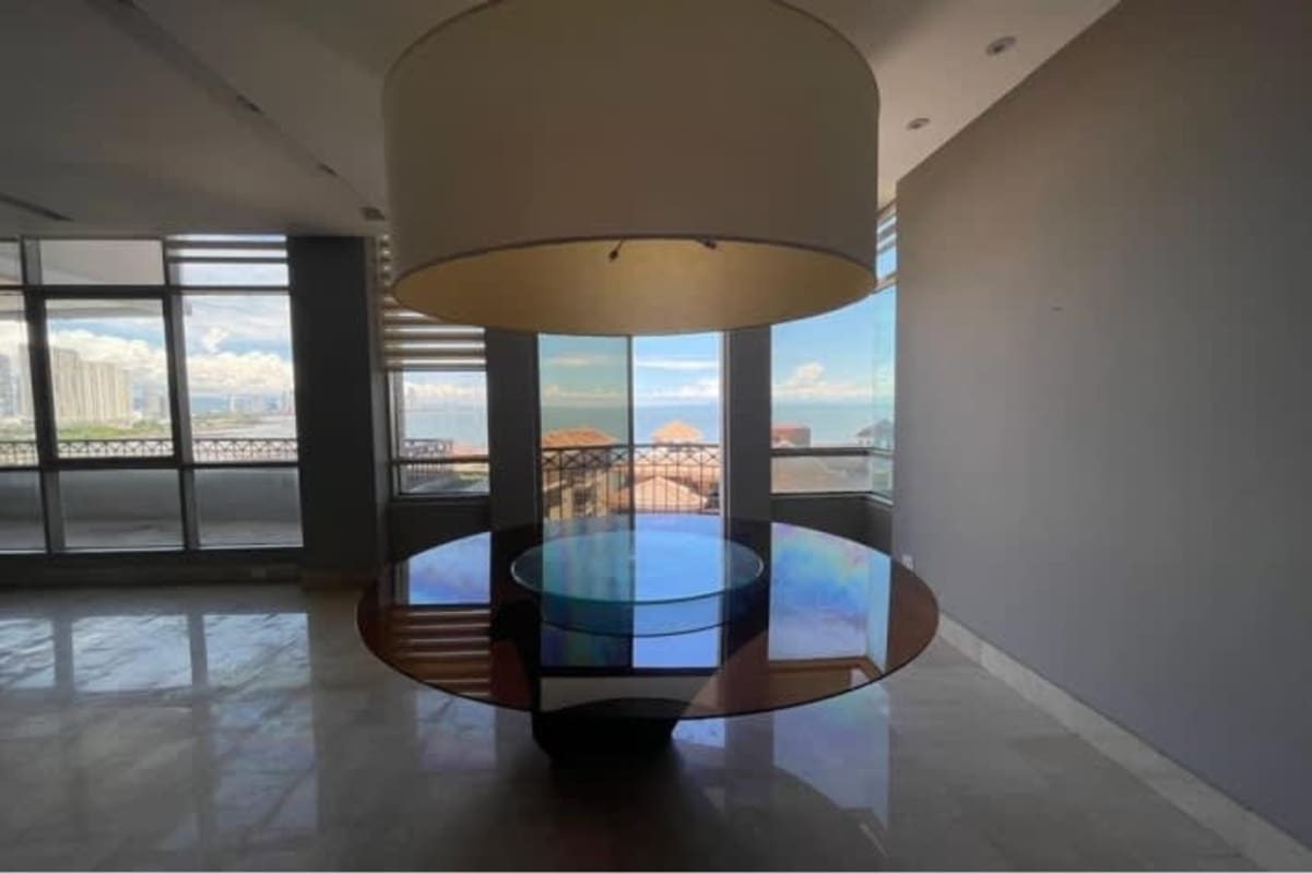 Modern kitchen with black cabinets, marble counters, island, stainless steel appliances at PH Pacific Point Panama