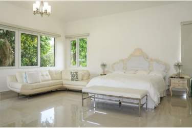 Open living dining room with large windows garden views at Santa Clara villa Panama