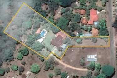 Spacious master bedroom with windows and garden views at beachfront villa Santa Clara Panama