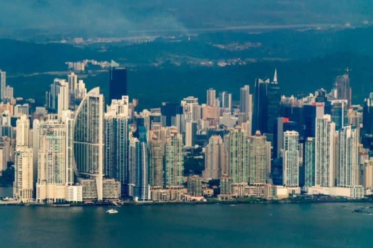Open dining area connected to modern kitchen with granite countertops at PH Mystic Point Towers Panama City