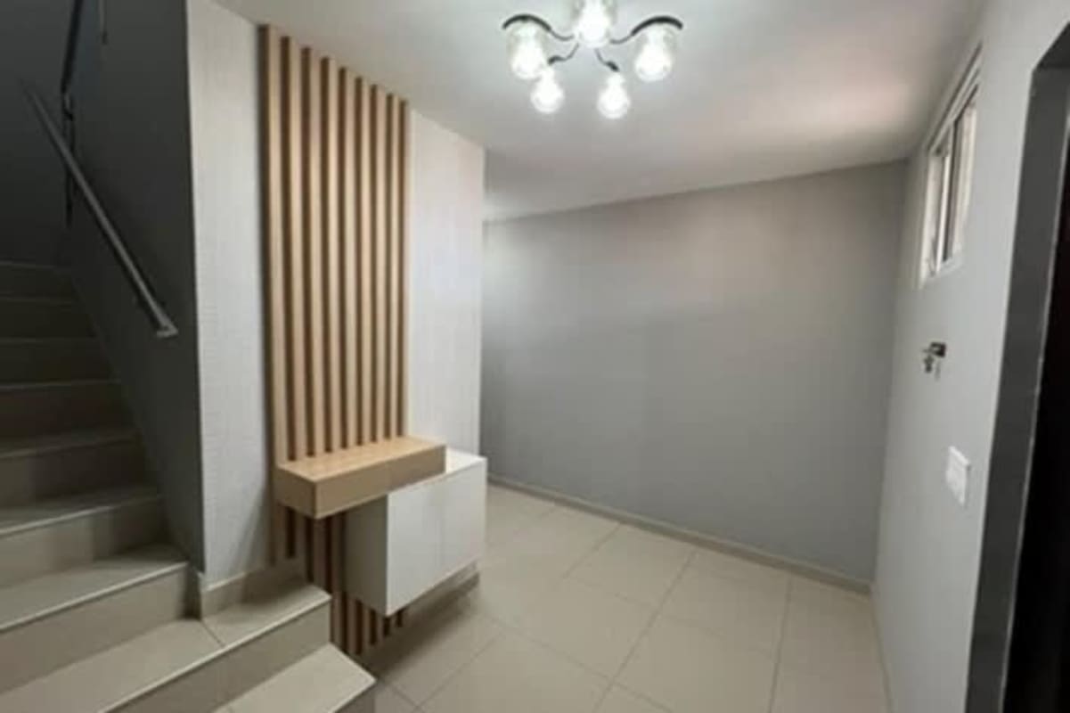 Entryway with modern wooden paneling and stairs in Urbanization El Doral Panama